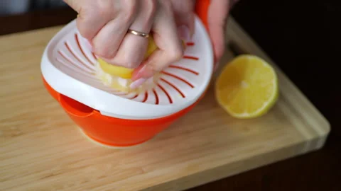Squeezing juice from a lemon fresh lemon juice Stock Footage 291333628