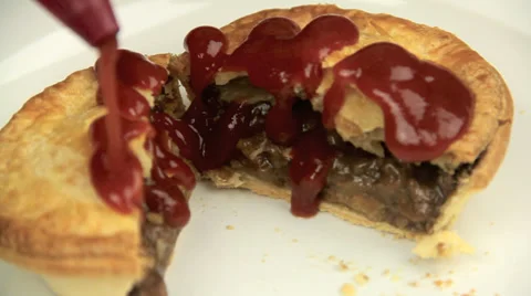 Squeezing Ketchup On Meat Pie Video stock 39449904