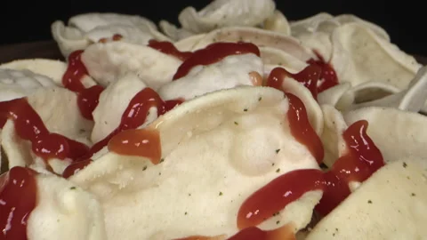Squeezing Ketchup on White Vegetable Chips Stock Footage 194886098