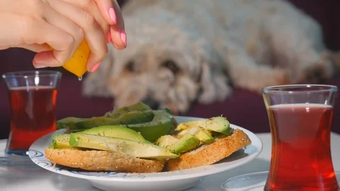 Squeezing lemon to avocado sandwiches Stock Footage 106403908