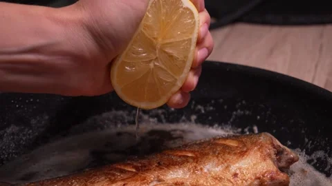 Squeezing Lemon on Grilled Fish. Stock Footage 258563143