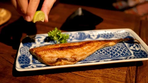 Squeezing Lemon on Grilled Fish Stock Footage 309917541