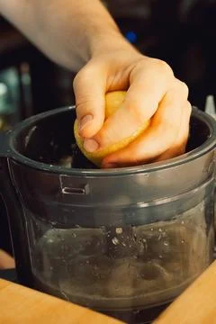 Squeezing  lemon in  home kitchen prepare fresh juice, add flavor to  dish or Stock Photos