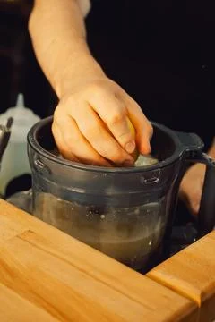 Squeezing  lemon in  home kitchen prepare fresh juice, add flavor to  dish or Stock Photos