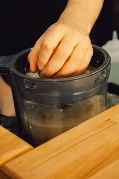 Squeezing  lemon in  home kitchen prepare fresh juice, add flavor to  dish or Foto stock