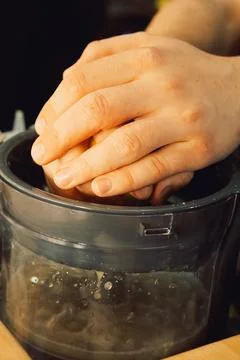 Squeezing  lemon in  home kitchen prepare fresh juice, add flavor to  dish or Stock Photos