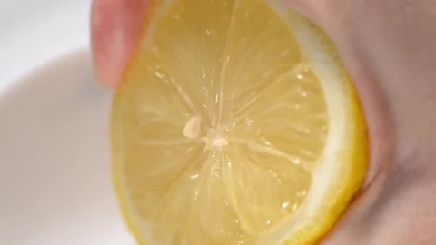 Squeezing lemon juice from half a lemon-1 Stock Footage 125500058