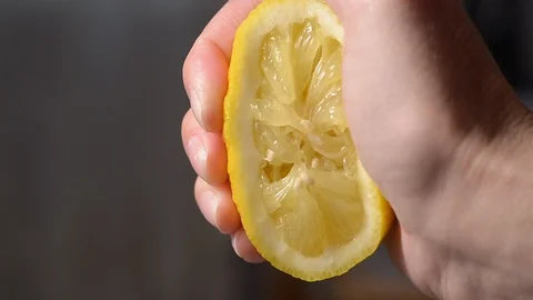 Squeezing lemon juice from half a lemon-2 Stock Footage 125500083