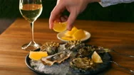 Squeezing Lemon Juice Of Oysters On The Half Shell. Seamless Cinemagraph Video Stock Footage
