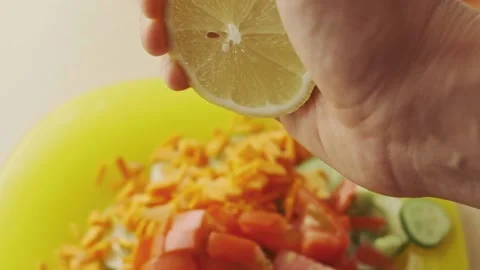 Squeezing lemon juice into a salad. Stock Footage 136727099