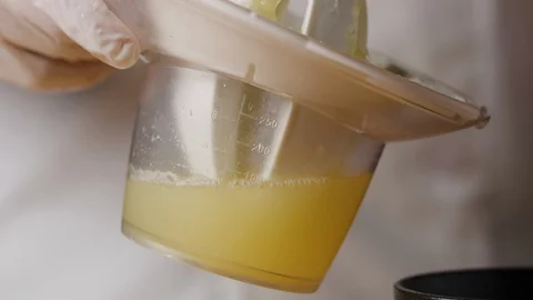 Squeezing lemon on juicer macro shot Stock Footage 128486930