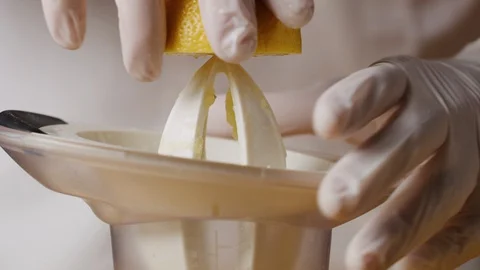 Squeezing lemon on juicer macro shot Stock Footage 128487324