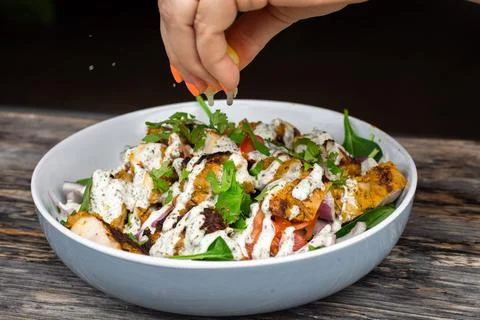 Squeezing Lemon over healthy chicken bowl Stock Photos