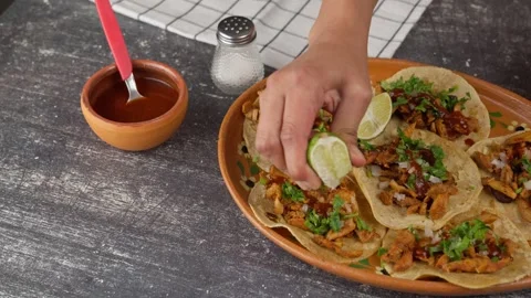 Squeezing a lemon over Mexican tacos Stock Footage 280363354