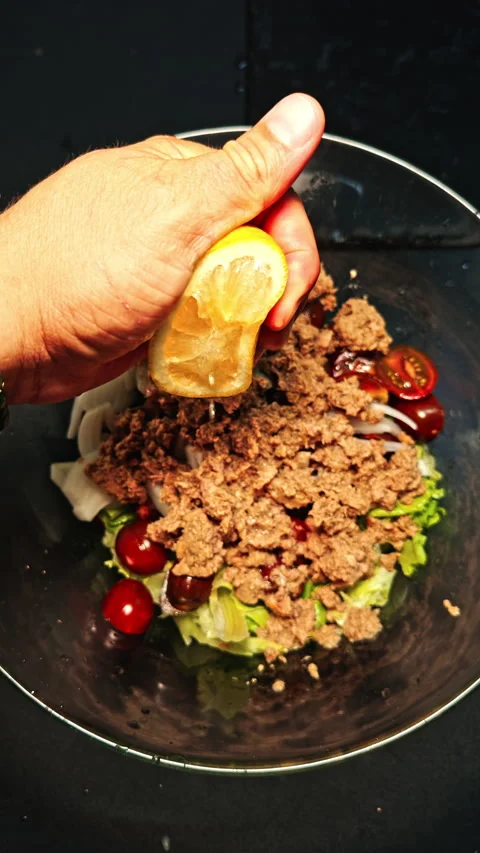 Squeezing lemon on salad close-up Stock Footage 277104826