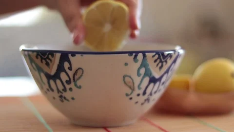 Squeezing lemon into soup Stock Footage 117337778