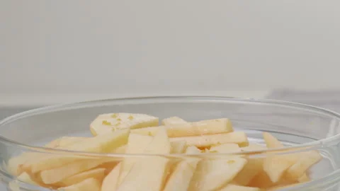 Squeezing lemon. Topping apple slices with lemon juice. Stock Footage 265560503