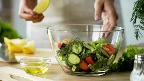 Squeezing Lemon Vegan Lettuce Salad Dressing. Vegan Raw Food On Diet. Stock-Footage 336588606