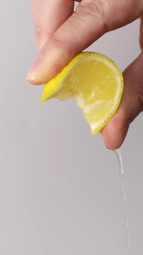 Squeezing Lemon Vertical Stock Footage 323246523