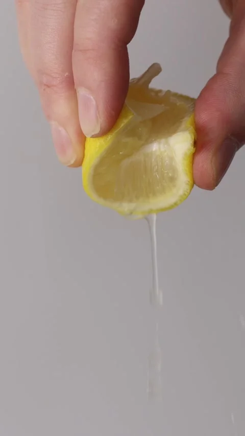 Squeezing Lemon Vertical Slow Stock Footage 323246507