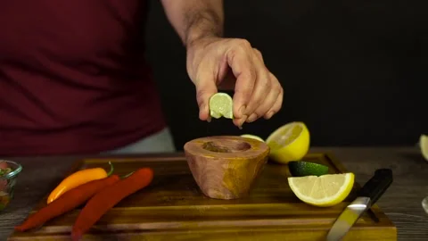 Squeezing a Lime in a Bowl Stock Footage 243604893