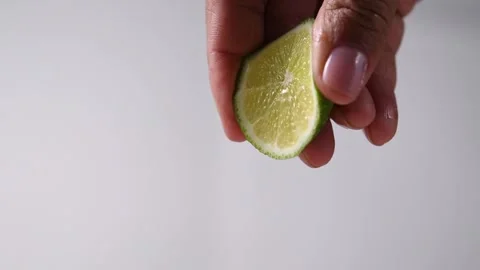 Squeezing lime juice with fingers. Stock Footage 131998488
