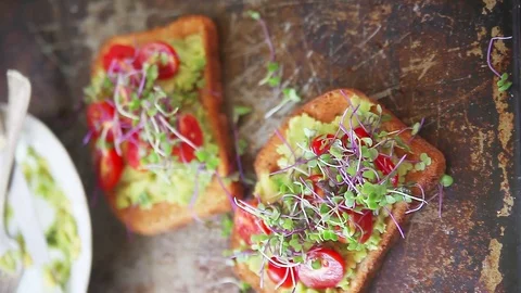 Squeezing lime juice over avocado toast Stock Footage 77811728