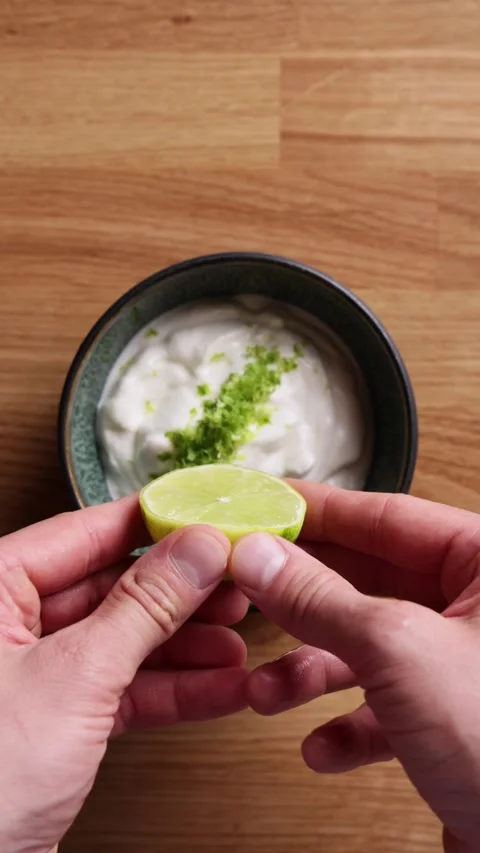Squeezing Lime Juice On Yogurt Top View Видео 331373599