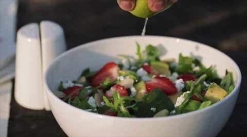 Squeezing lime on a salad Stock-Footage 54544471