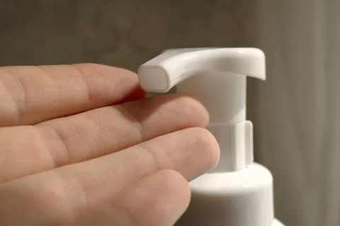 Squeezing liquid soap into palm Stock Photos