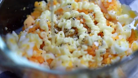 Squeezing Mayonnaise Sauce Onto Smashed Eggs Stock Footage 131412143