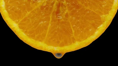 Squeezing an orange half on black background. Citrus fruit source of vitami.. Stock Footage 265840960