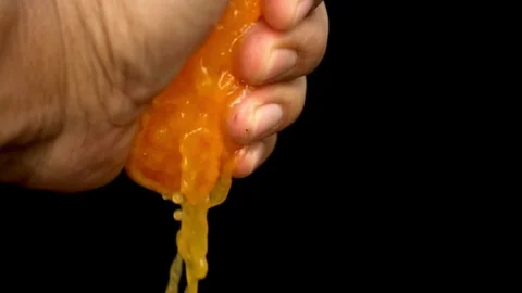 Squeezing an orange half on black background. Citrus fruit source of vitamins Stock-Footage 336588874