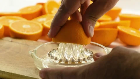 Squeezing an orange by hand Видео 281446803