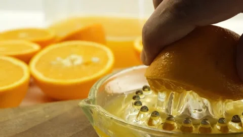 Squeezing an orange by hand Видео 281448347