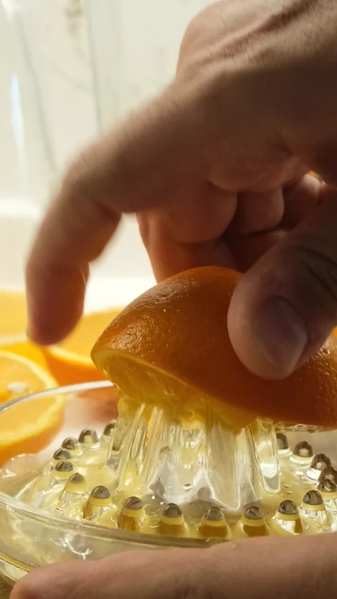 Squeezing An Orange By Hand Vertical Video Видео 334874043