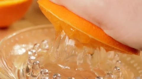 Squeezing Orange in Kitchen CU Stock Footage 22823962