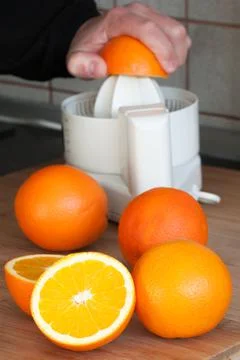 Squeezing orange Stock Photos