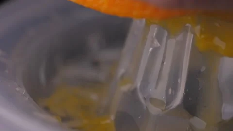 Squeezing orange using squeezer slow motion Stock Footage 148341278