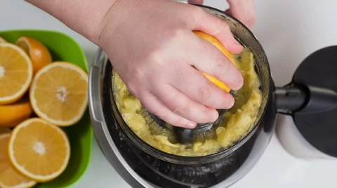 Squeezing oranges to make a fresh and natural juice Stock Footage 45967654