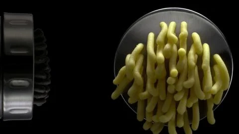 Squeezing out a colored dough through the nozzle Stock Photos