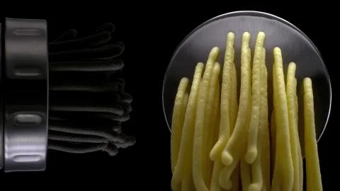 Squeezing out a colored dough through the nozzle Stock Photos