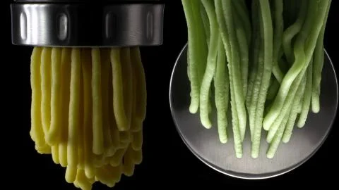 Squeezing out a colored dough through the nozzle Stock Photos