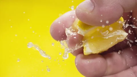 Squeezing out fresh Lemon juice drains from the pulp Super slow-mo 1000 fps Stock Footage 163962143