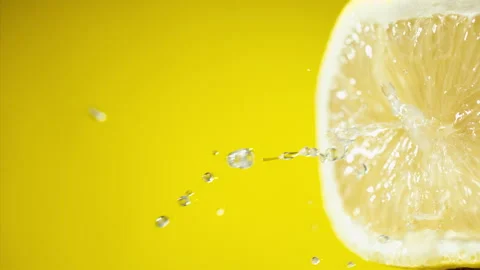 Squeezing out fresh Lemon juice drains from the pulp Super slow-mo 1000 fps Stock Footage 163962404