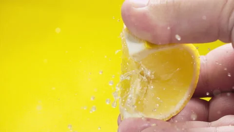 Squeezing out fresh Lemon juice drains from the pulp Super slow-mo 1000 fps Stock Footage 163962531