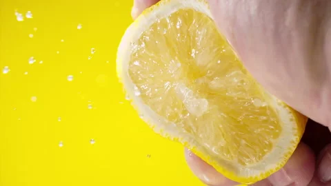 Squeezing out fresh Lemon juice drains from the pulp Super slow-mo 1000 fps Stock Footage 163962941