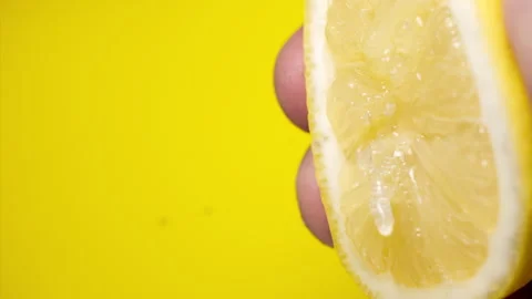 Squeezing out fresh Lemon juice drains from the pulp Super slow-mo 1000 fps Stock Footage 276731993
