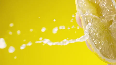 Squeezing out fresh Lemon juice drains from the pulp Super slow-mo 1000 fps Stock Footage 281564460