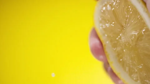Squeezing out fresh Lemon juice drains from the pulp Super slow-mo 1000 fps Stock Footage 281564528